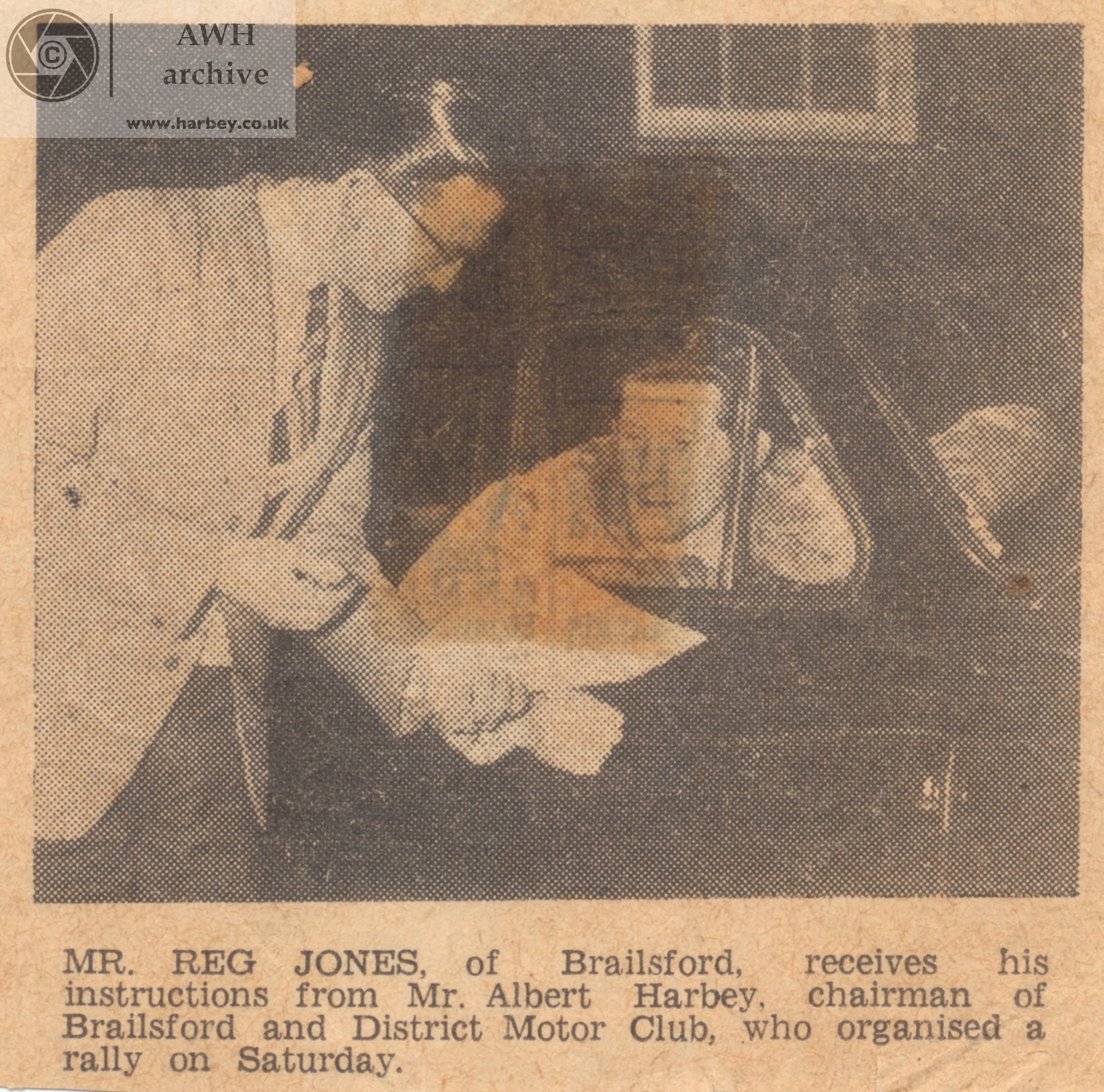 Reg Jones of the Brailsford and District Motor Club is given instructions by Mr Albert Harbey
